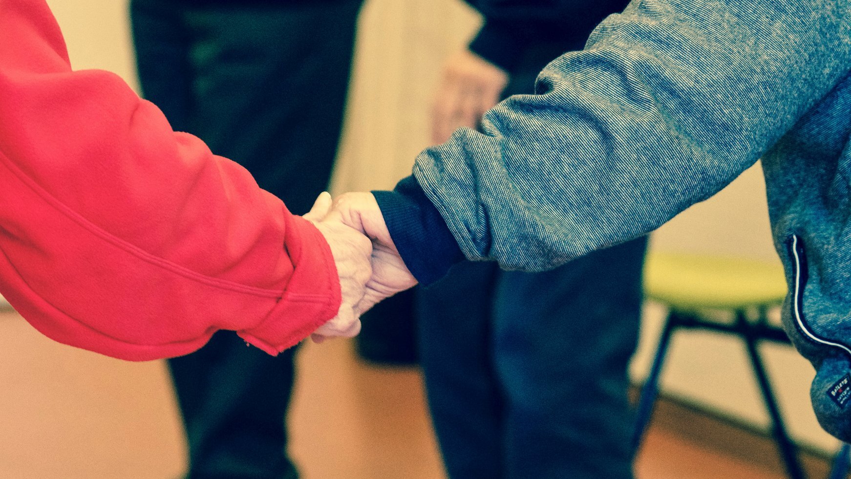 2 persons holding their hands 233223