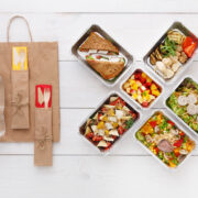 Healthy food take away boxes top view wooden table