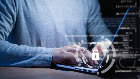 Programmer typing working laptop programming about cyber security