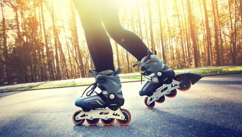 Teenage girl on roller skates at summer