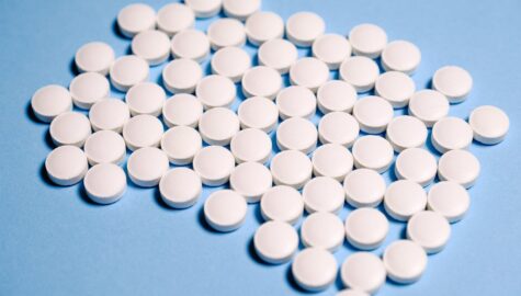 White medication pill on blue textile 3683079