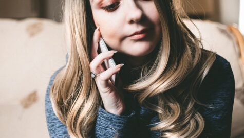 Woman in gray top using her mobile phone 876285