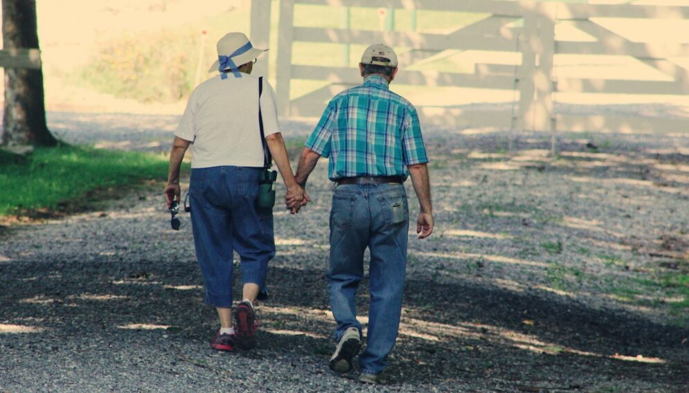 Old couple walking while holding hands 906111