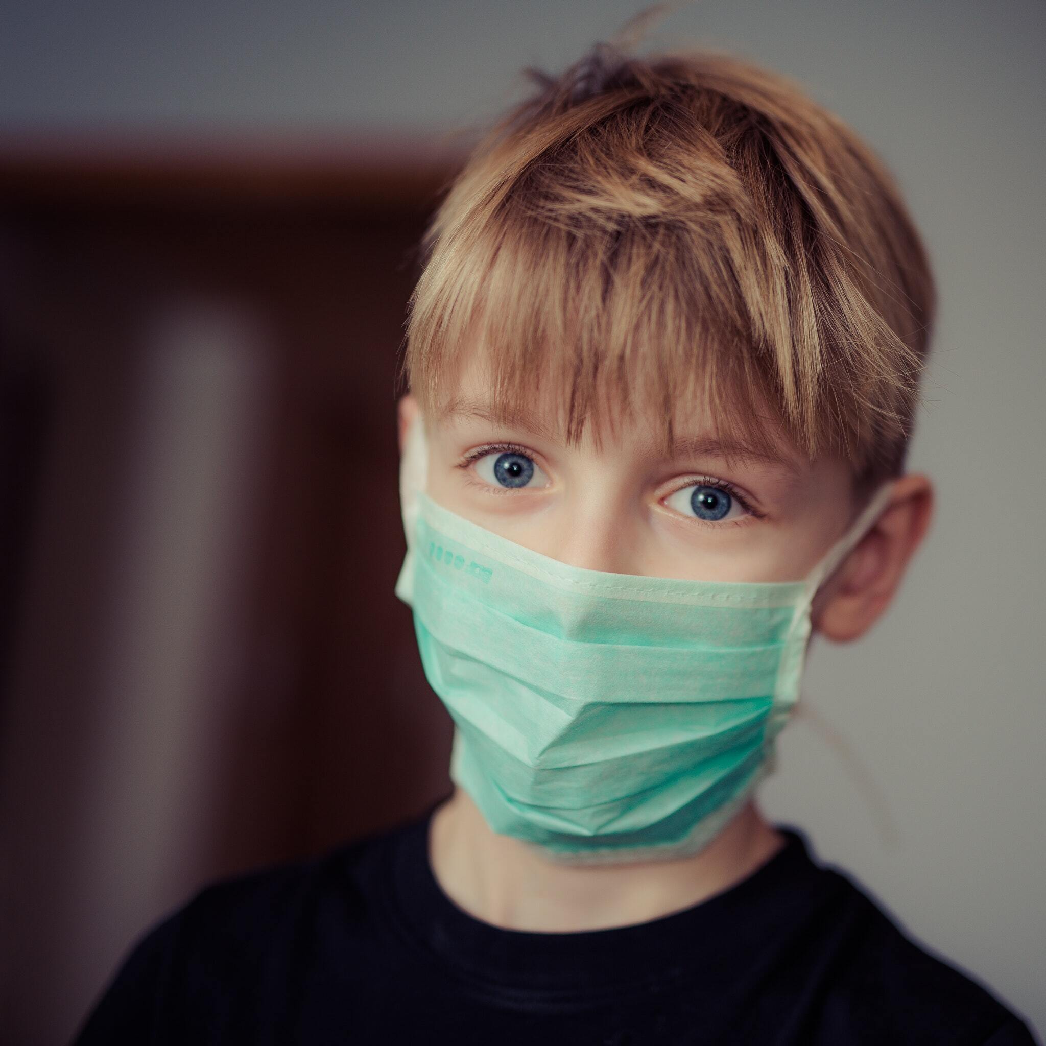 Boy wearing surgical mask 695954