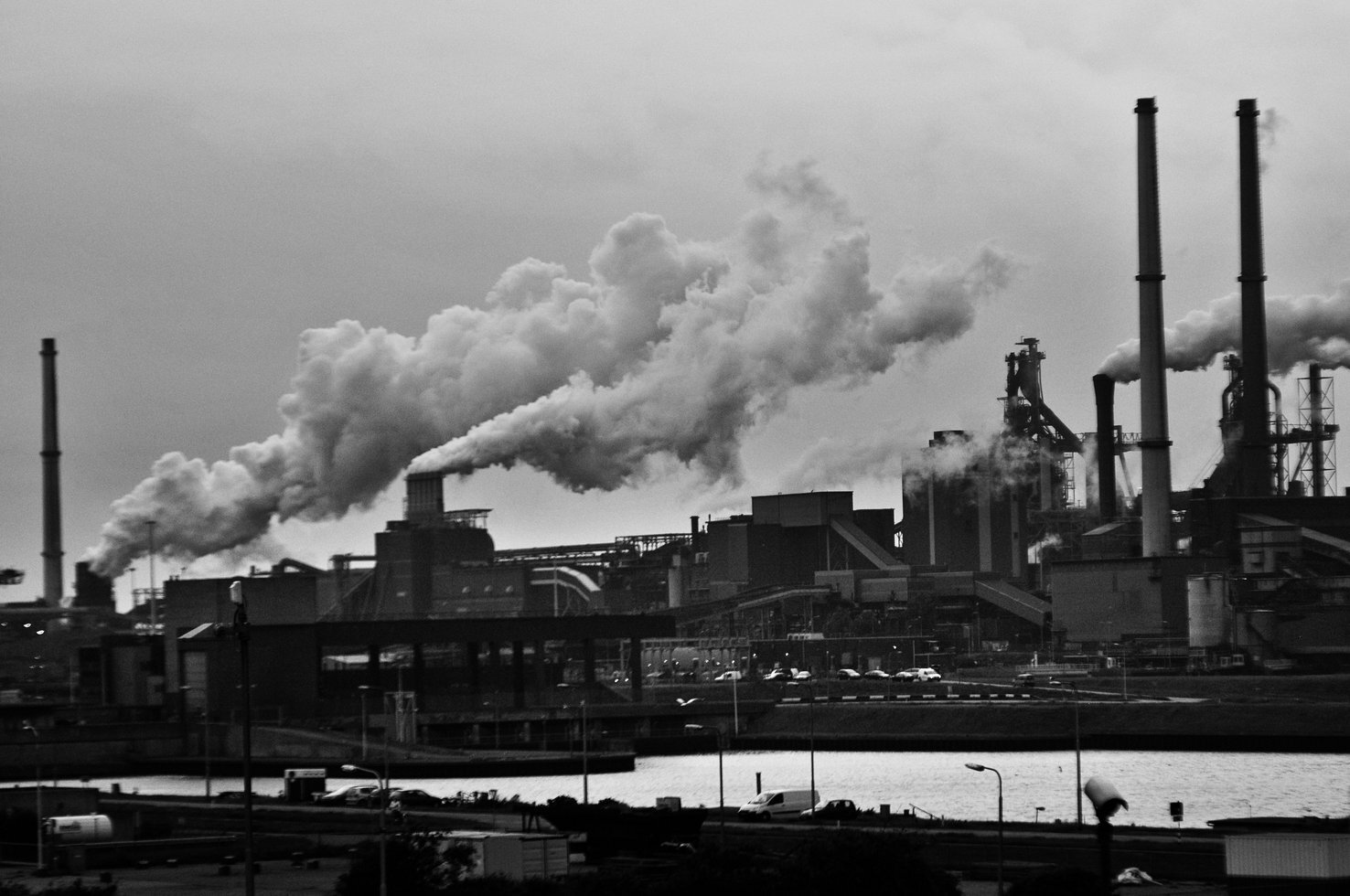 Grayscale photography of locomotive train beside factory 682078