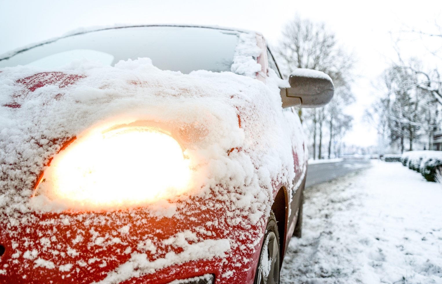 Snow covered red sedan 730901
